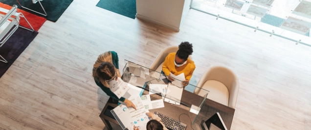 Image a people sitting at a desk in a bank