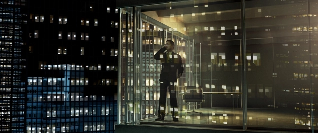 Image of a person standing at a window inside a skyscraper