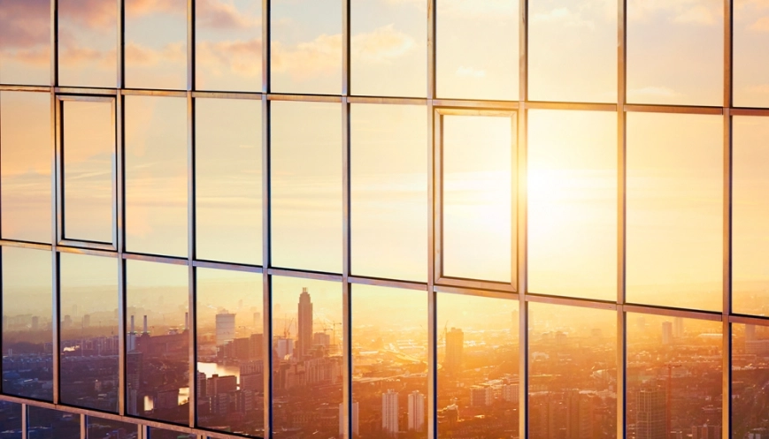 Image of city in the reflection of a glass building